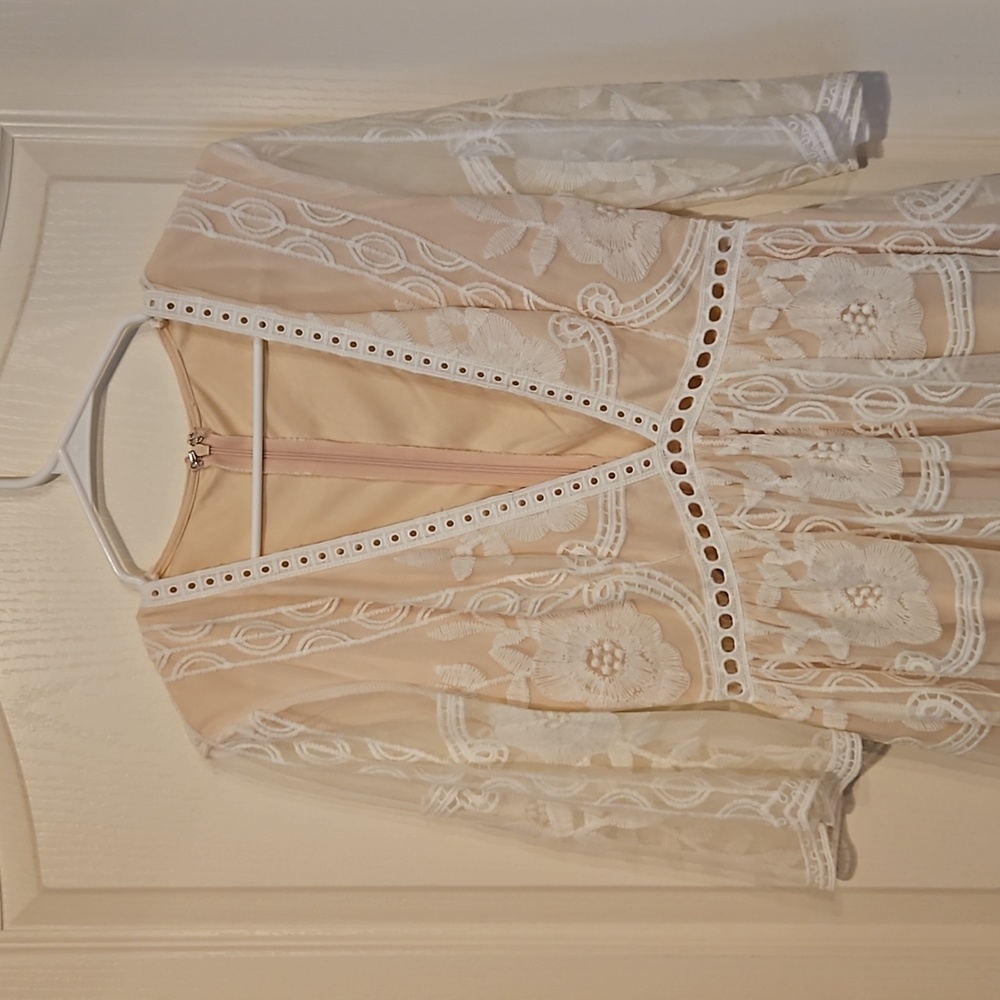 NWOT lace deep v-neck line with eye hook closure. Soft white lace over nude